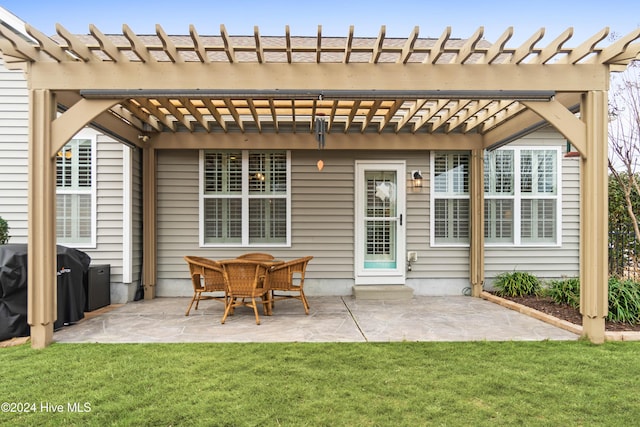 rear view of house with a lawn, a pergola, and a patio