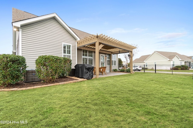 rear view of property featuring a yard, a pergola, fence, and a patio