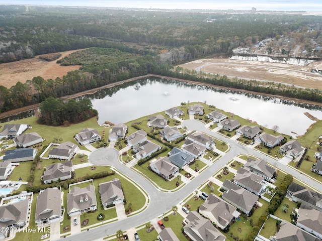 bird's eye view featuring a water view, a residential view, and a wooded view