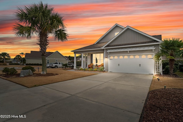 view of front facade featuring board and batten siding, an attached garage, and concrete driveway