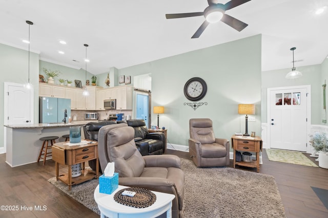 living room featuring dark wood-type flooring and ceiling fan