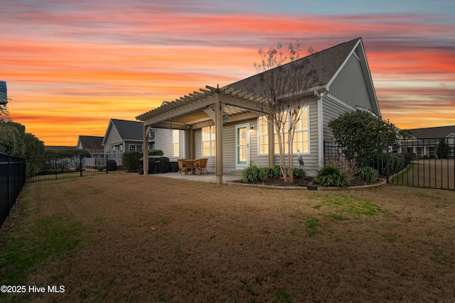rear view of property featuring a lawn, a pergola, a fenced backyard, and a patio area