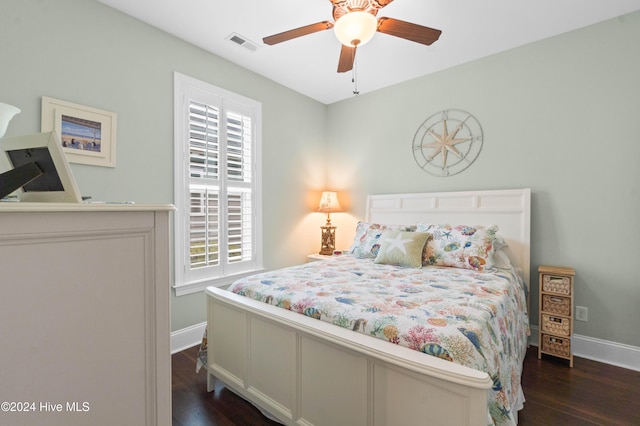 bedroom with dark hardwood / wood-style flooring and ceiling fan