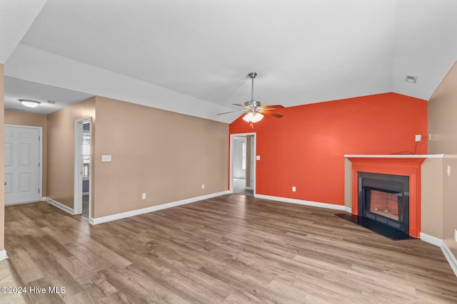 unfurnished living room with ceiling fan, light hardwood / wood-style floors, and lofted ceiling