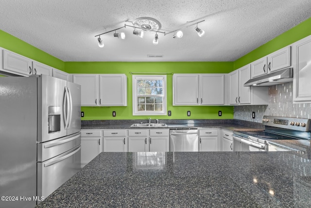 kitchen featuring white cabinetry, sink, stainless steel appliances, and a textured ceiling