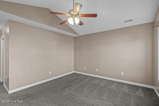 empty room with carpet flooring, ceiling fan, and vaulted ceiling