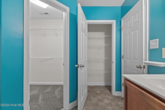 bathroom featuring vanity and a textured ceiling