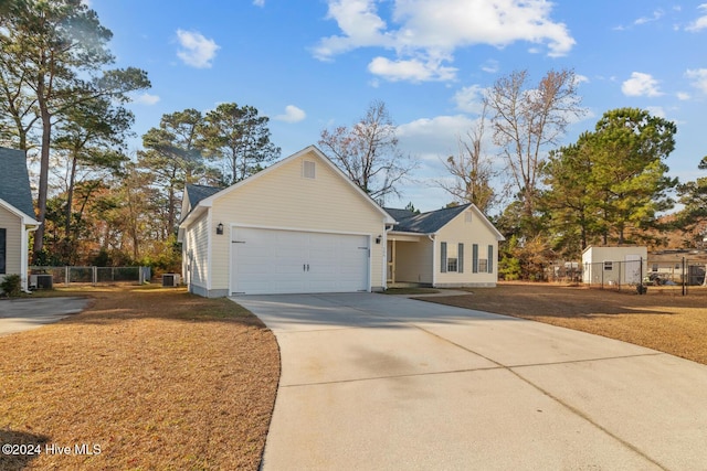 view of front of property featuring a garage and central AC unit