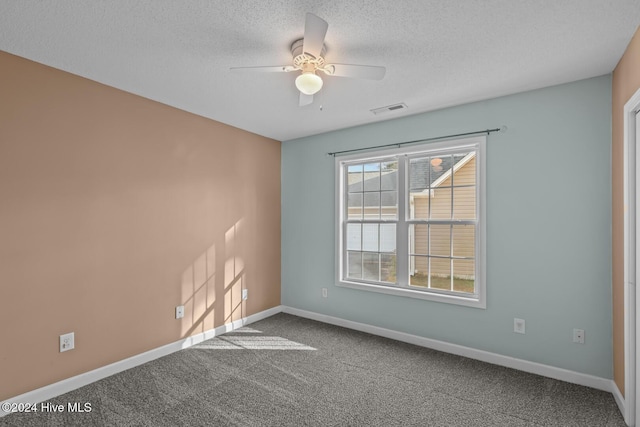 empty room with carpet flooring, a textured ceiling, and ceiling fan