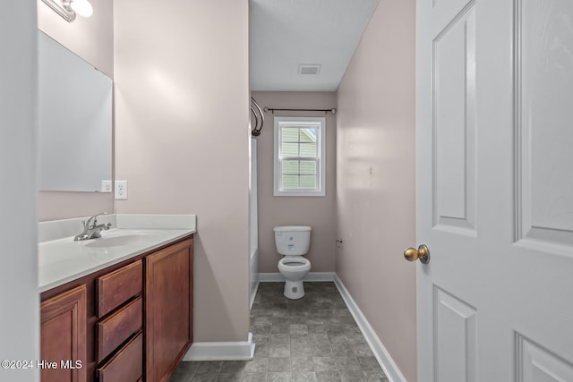 bathroom featuring vanity, toilet, and a bath