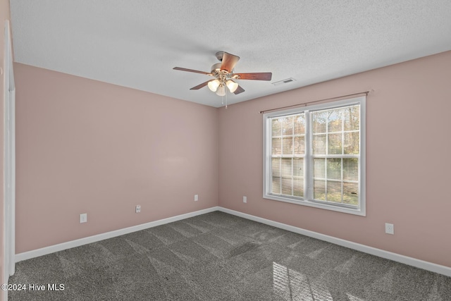 carpeted empty room featuring a textured ceiling and ceiling fan