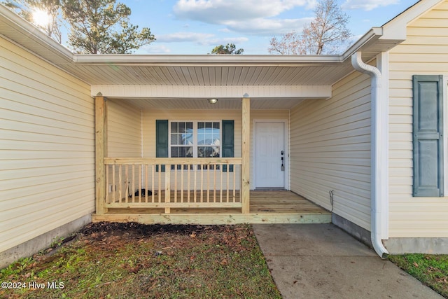 view of exterior entry with a porch