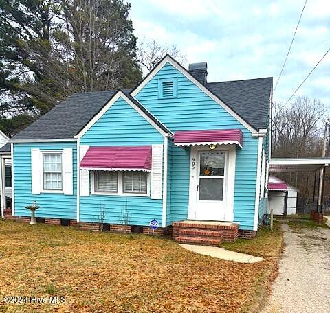 bungalow-style home featuring a front yard