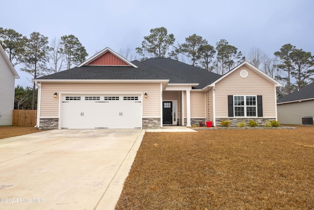 craftsman-style home featuring central AC and a garage