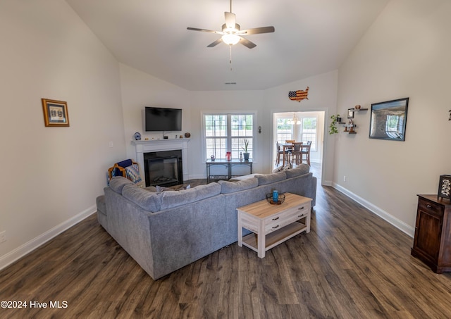 living room with dark hardwood / wood-style flooring, vaulted ceiling, and ceiling fan