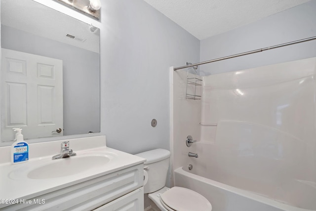 full bathroom featuring shower / washtub combination, vanity, a textured ceiling, and toilet