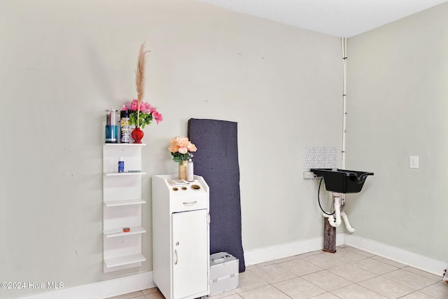 bathroom with tile patterned flooring and a textured ceiling