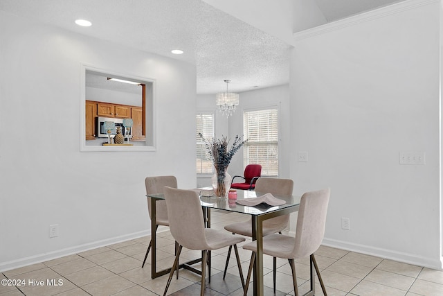 dining room featuring light tile patterned flooring, a chandelier, and a textured ceiling