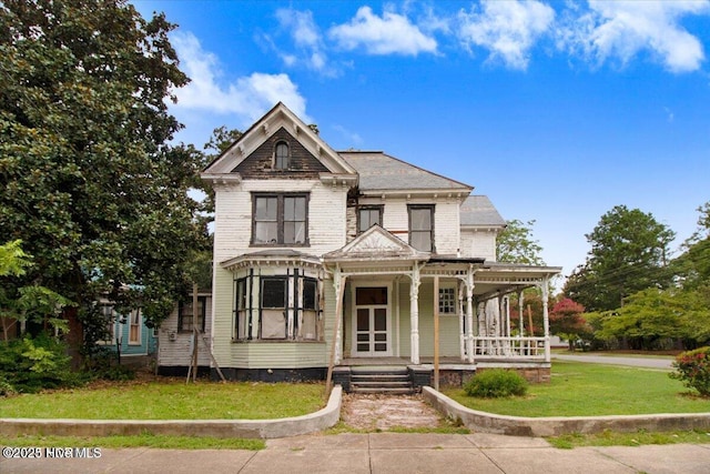 victorian home featuring a porch and a front yard