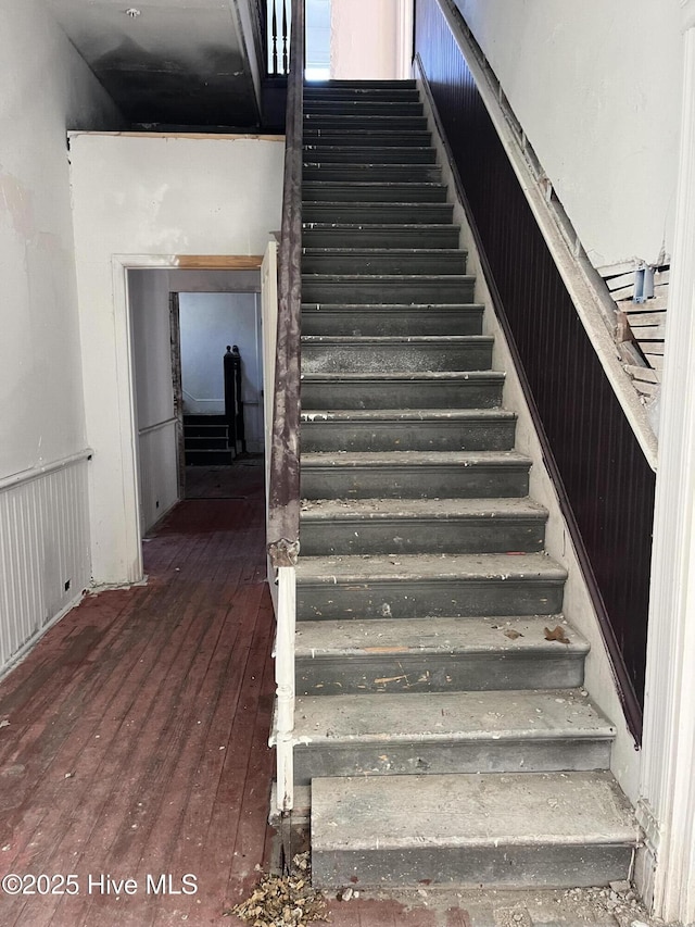 staircase with hardwood / wood-style flooring