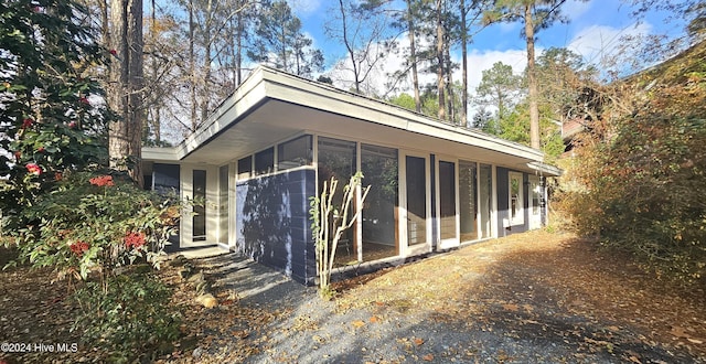 view of side of home with a sunroom