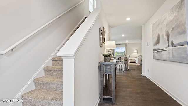 stairway with hardwood / wood-style floors