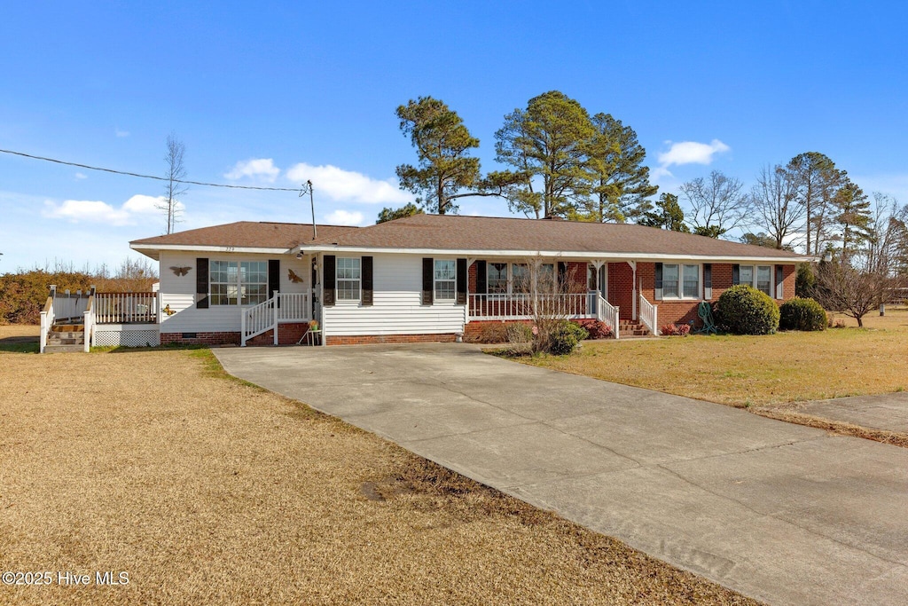 ranch-style house with a porch and a front yard