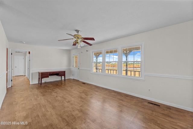 unfurnished room with light hardwood / wood-style flooring and ceiling fan