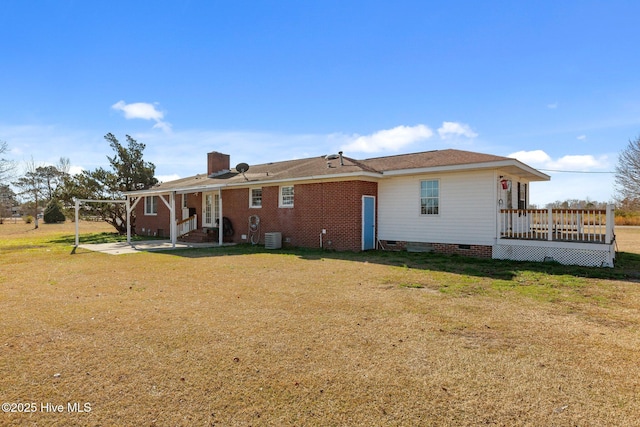 back of house with a deck, central AC unit, and a lawn