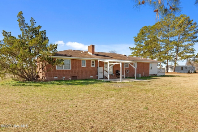 back of property featuring a yard and a patio