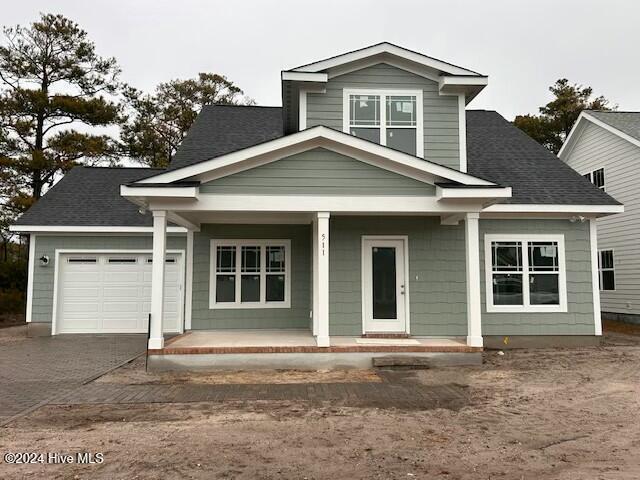 view of front of home with a porch and a garage