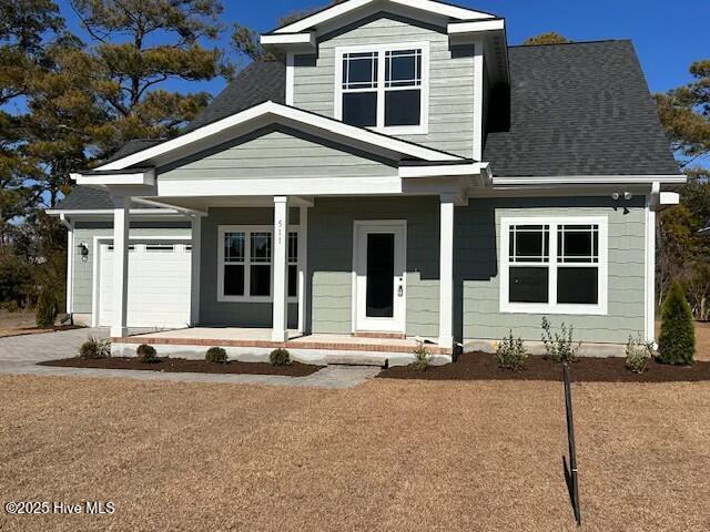 view of front of property with a garage and covered porch