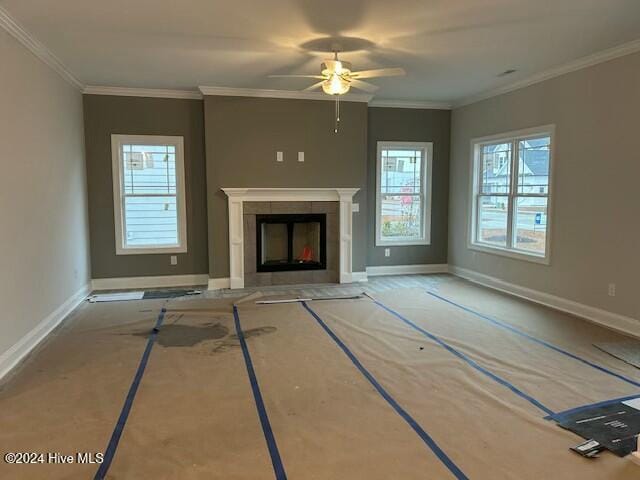 unfurnished living room with a fireplace, ceiling fan, and ornamental molding