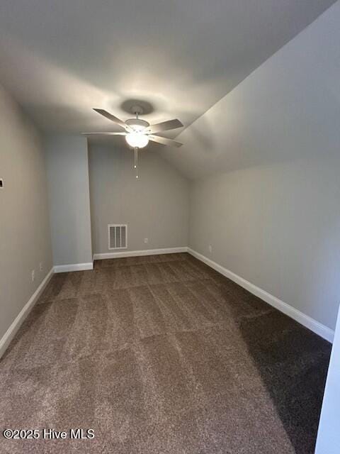 additional living space featuring vaulted ceiling, ceiling fan, and dark carpet