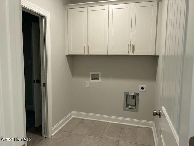 laundry area featuring cabinets, light tile patterned floors, washer hookup, and hookup for an electric dryer