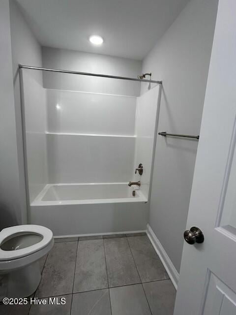 bathroom featuring  shower combination, tile patterned floors, and toilet