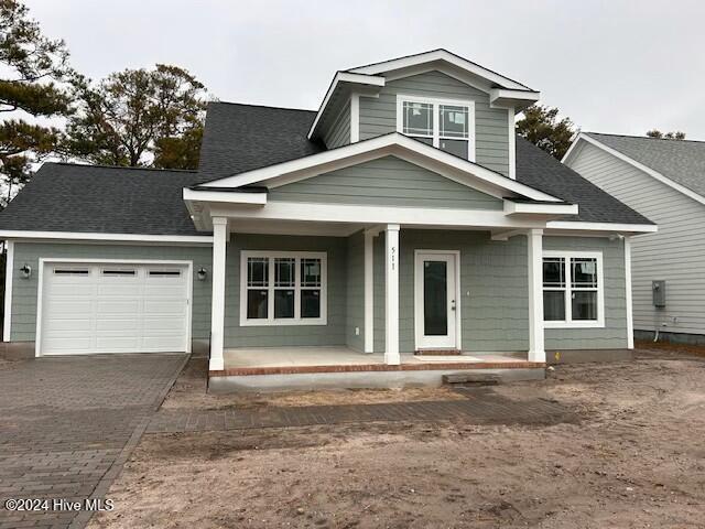 view of front of house featuring a porch and a garage