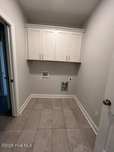 clothes washing area with hookup for a washing machine, electric dryer hookup, light tile patterned floors, and cabinets