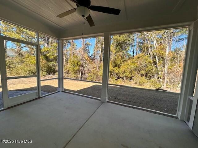 unfurnished sunroom featuring ceiling fan