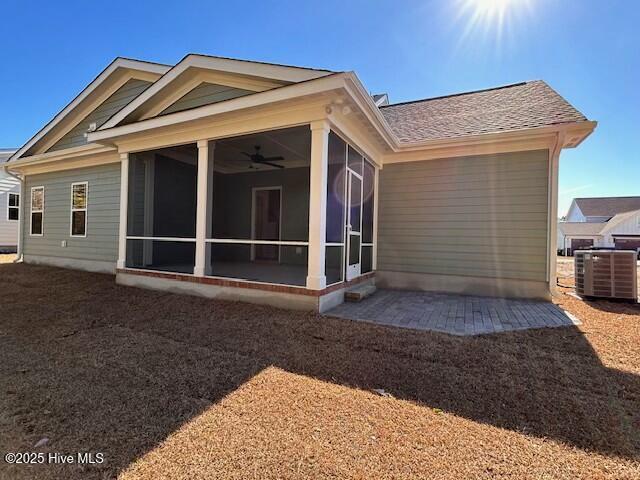 back of house featuring central AC, ceiling fan, a patio, and a sunroom