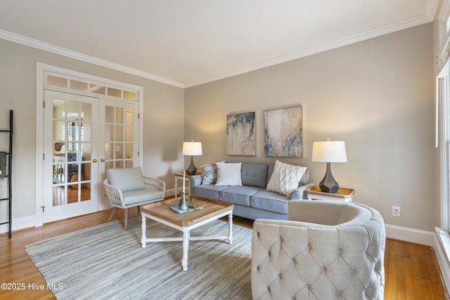 living room featuring ornamental molding, hardwood / wood-style flooring, and french doors