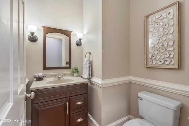 bathroom featuring toilet and vanity