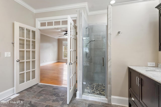 bathroom with a shower with door, ceiling fan, french doors, vanity, and ornamental molding