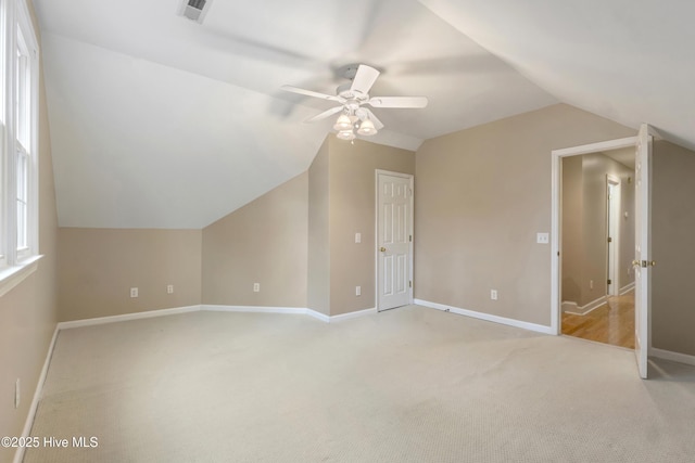 bonus room with ceiling fan, light carpet, and lofted ceiling