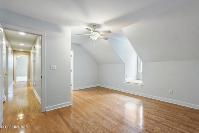 additional living space with ceiling fan, light hardwood / wood-style flooring, and lofted ceiling