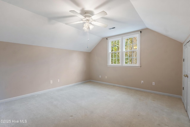 bonus room with ceiling fan, light colored carpet, and lofted ceiling