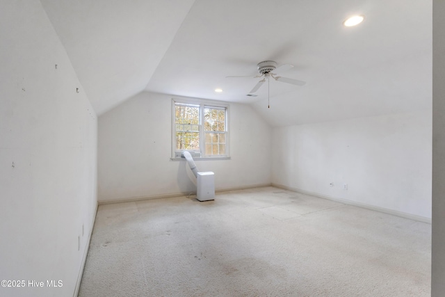 bonus room with ceiling fan, light carpet, and lofted ceiling