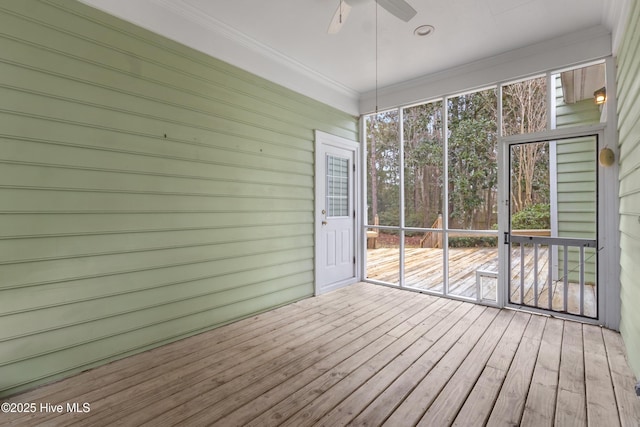 unfurnished sunroom with ceiling fan