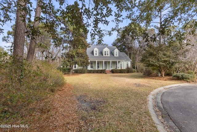 cape cod house with a front yard