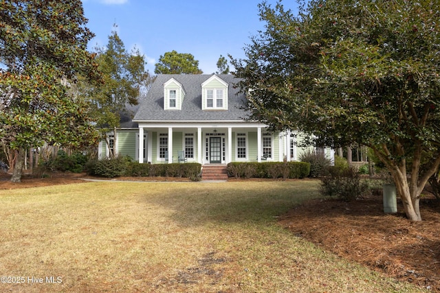 cape cod house featuring a front lawn and a porch